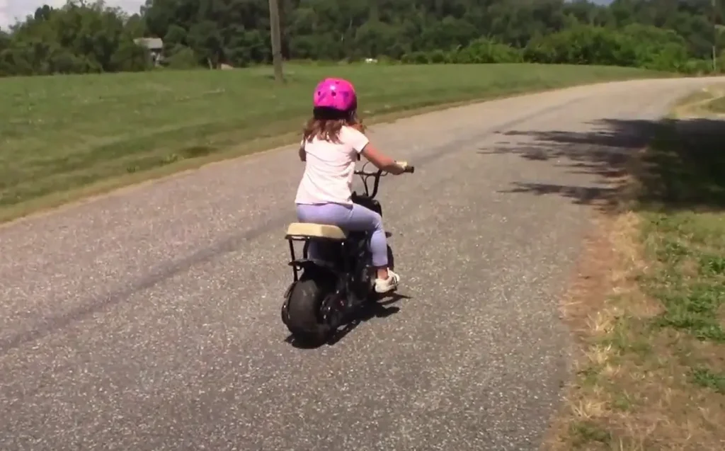 a kid or beginner riding her minibike first time